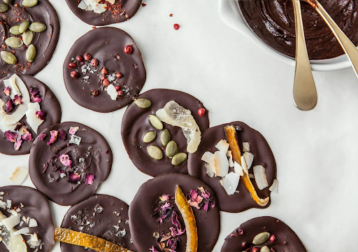 Schoolyard Snacks’ sugar-free chocolate recipe with pumpkin seeds, on a white background.